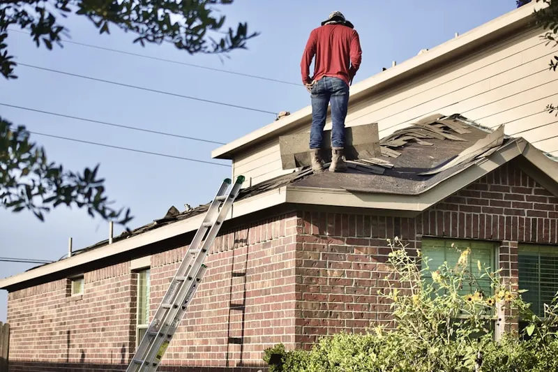 Professional roofer working on a residential roof in Panther Valley